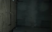 Guy pissing in dark cellar with wooden slats