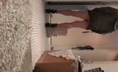 Woman shitting in shorts on tiled floor