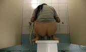 Woman shitting on toilet with enema tube