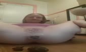 Shaved babe shitting a very big one