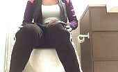 Busty babe shits over toilet