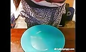 Girl shitting on a blue plate