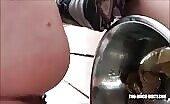 Girl shitting a long brown turd into a metal bowl