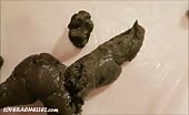 Curly haired lady shows her warm turd