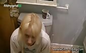 Blonde girl shitting on toilet with shirt