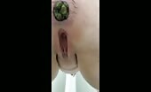 Woman shitting green turds into her pussy
