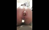 Woman shitting in the toilet with a big turd hanging out