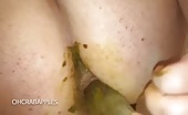 Woman shitting into a clear bottle, green crap smeared on ass