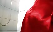 Blonde woman shitting into a glass in the bathroom