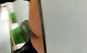 Woman shitting in boots on tiled floor