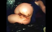 Woman shitting on black plastic with brown mess