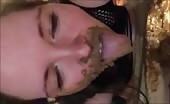 Woman smearing shit on her face and tits in black mesh