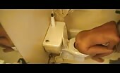 Emptying her bowels in the toilet
