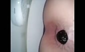 Girl shitting a dark turd in the toilet  