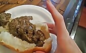 Woman shitting into a bread bun on a plate