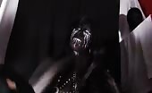Woman in black shitting with white paint on her face