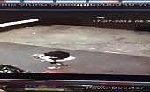 Blonde shitting in shorts on concrete