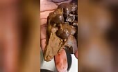 Ebony lady pushing pebbles into the toilet
