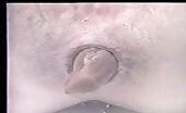 Woman shitting in bathtub, hands on her ass