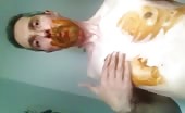 Man smearing brown shit on his face and chest