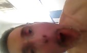 Man shitting and holding turd in his mouth