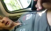 Man pissing in car while holding phone