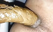 Guy shitting a long brown turd into his ass